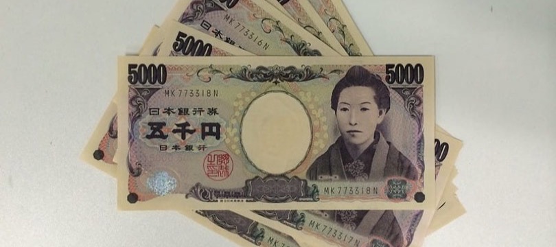 Japanese 5,000 yen banknotes representing the Bank of Japan's monetary policy