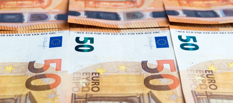 Close-up of 50-euro banknotes laid out in overlapping rows, filling the whole frame