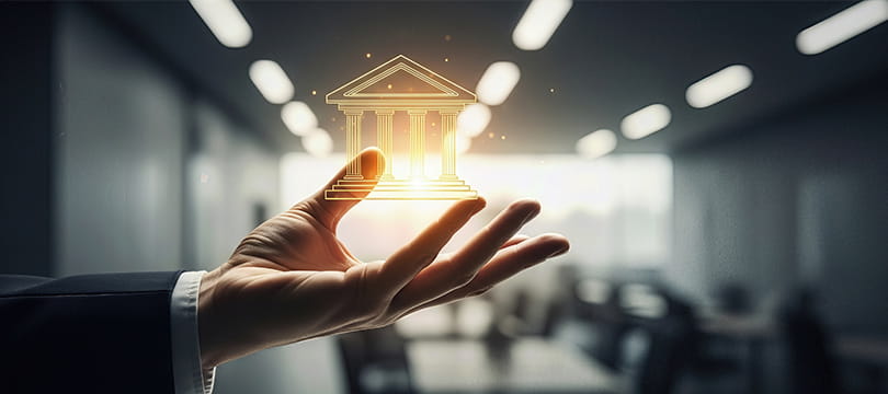 A hand holding a glowing treasury building icon, symbol of government bonds
