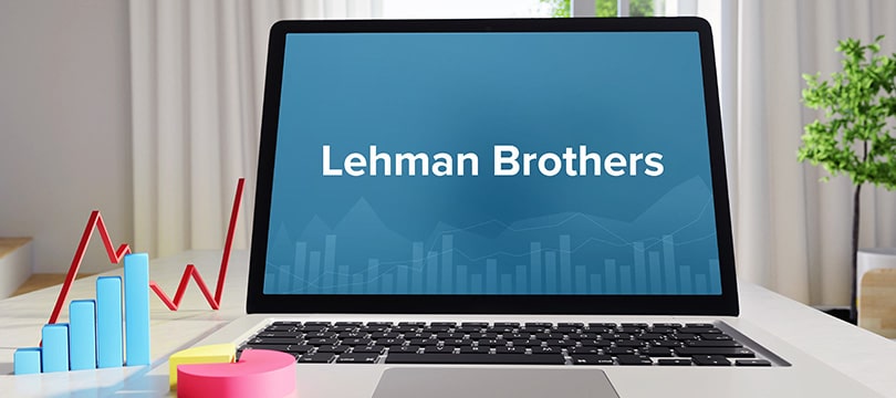 Lehman Brothers name on a laptop screen next to a falling market chart