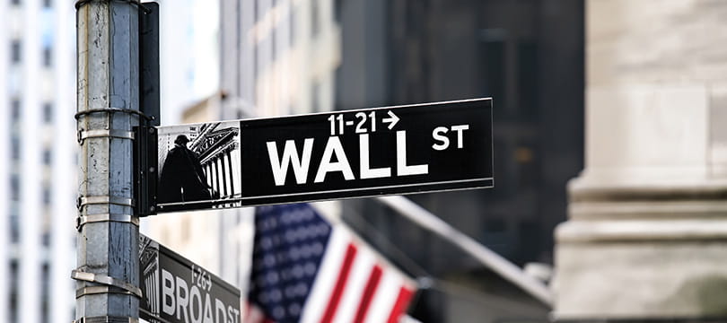 Wall Street street sign in front of a classical building facade