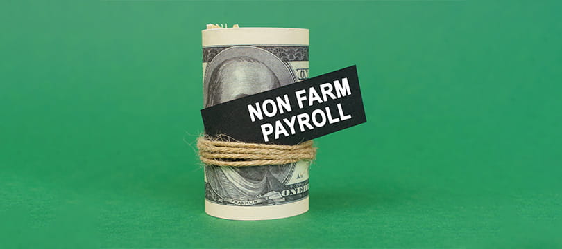 A roll of banknotes labeled non-farm payroll on a green background