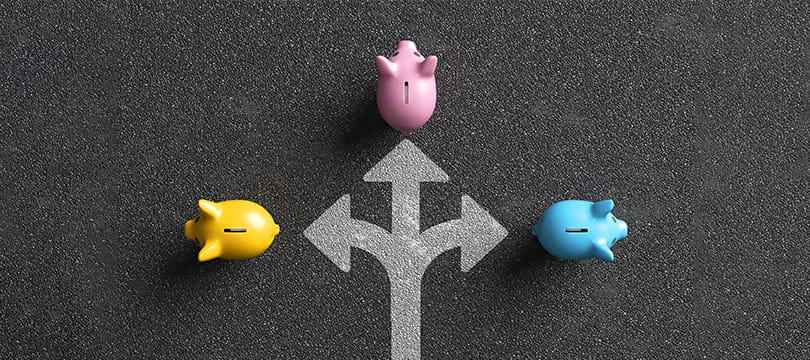 Small figures placed at a crossroads with arrows pointing in different directions