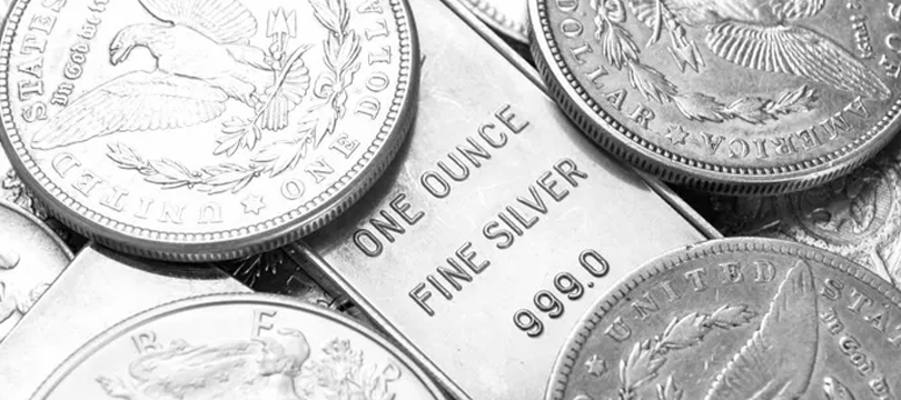 Silver coins and one-ounce fine silver rounds stacked together